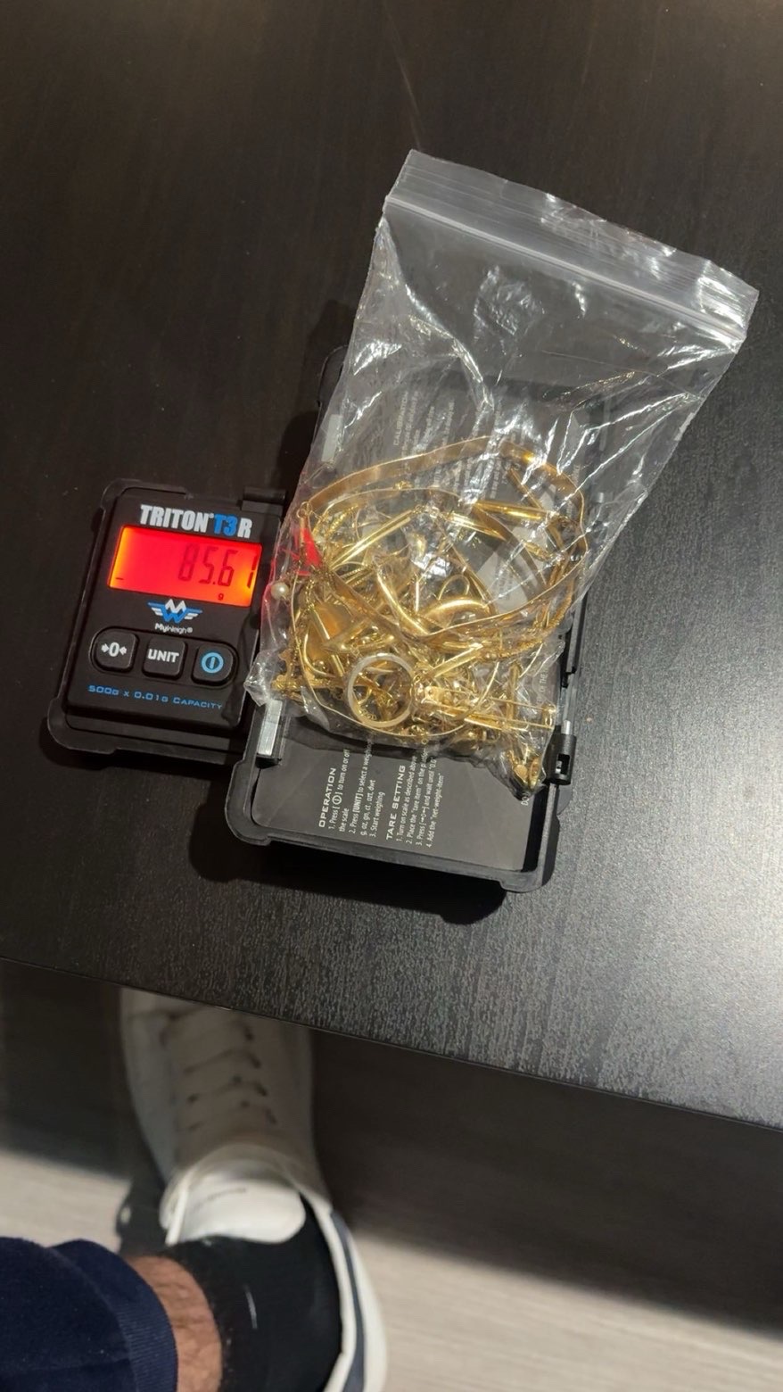 Bag of gold jewellery on a digital scale